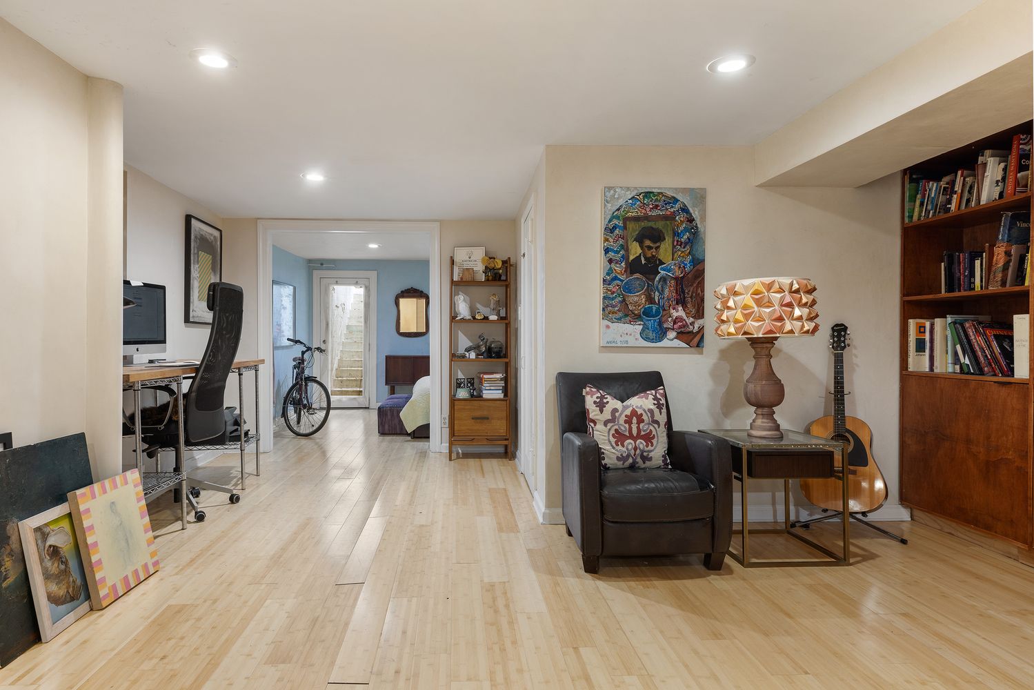 a living room with furniture and a book shelf