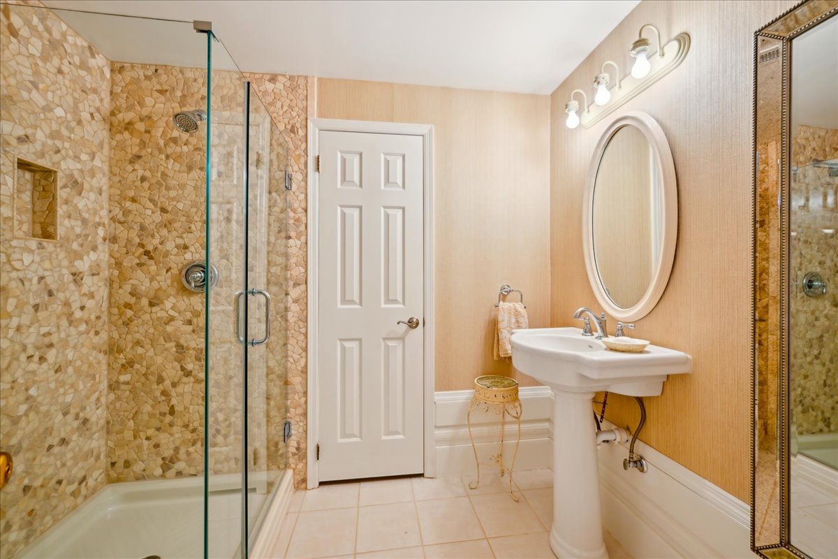 Johnston Drive Watchung, NJ 07069 - Photo 55 of 85 a bathroom with a sink a mirror and a shower