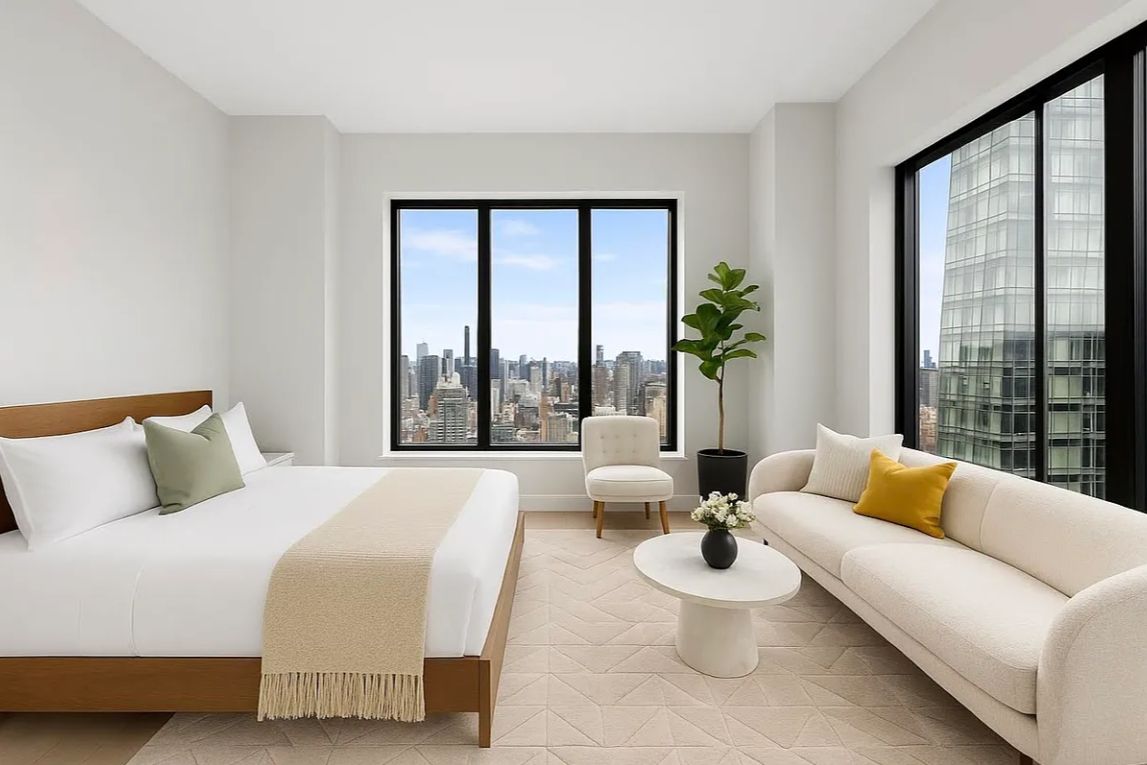 a spacious bedroom with a bed and a large window