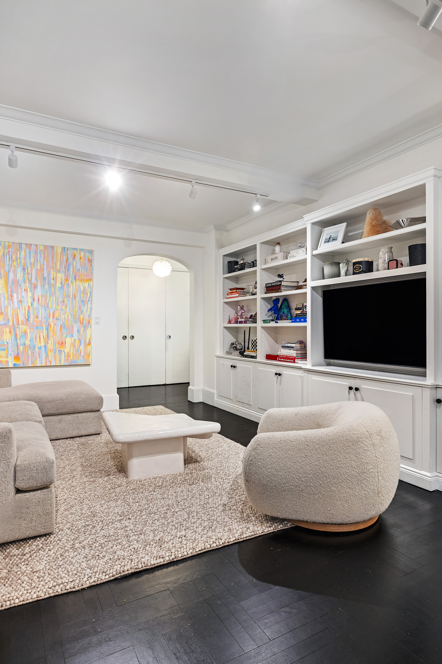 325 East 79th Street, Unit 6C Manhattan, NY 10075 - Photo 6 of 17 a living room with furniture and a flat screen tv