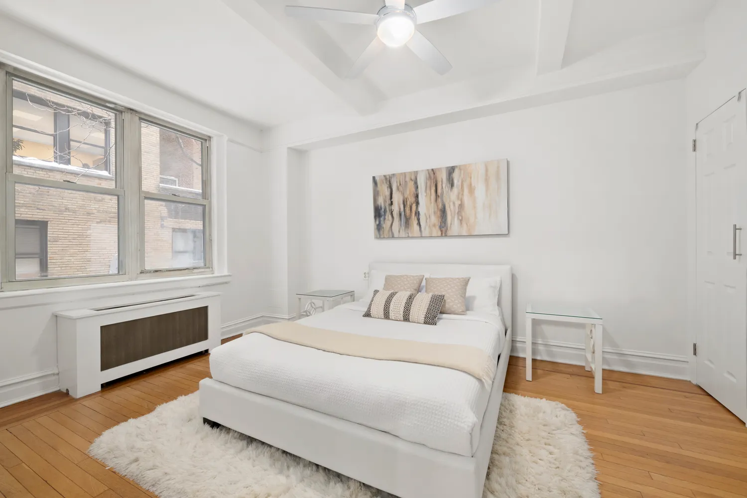 a bedroom with a bed and a large window