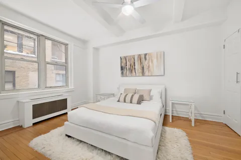 a bedroom with a bed and a large window