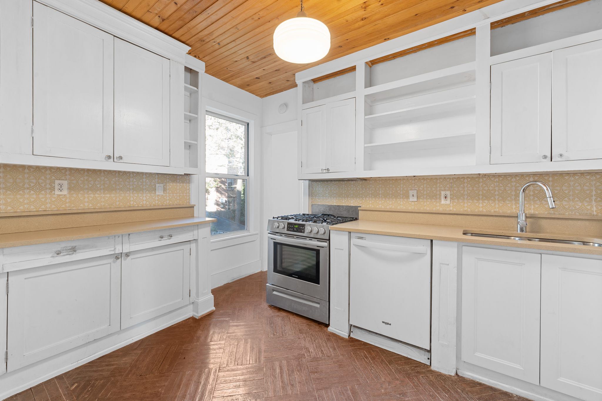 428 East 18th Street Brooklyn, NY 11226 - Photo 5 of 19 a kitchen with granite countertop white cabinets and white appliances