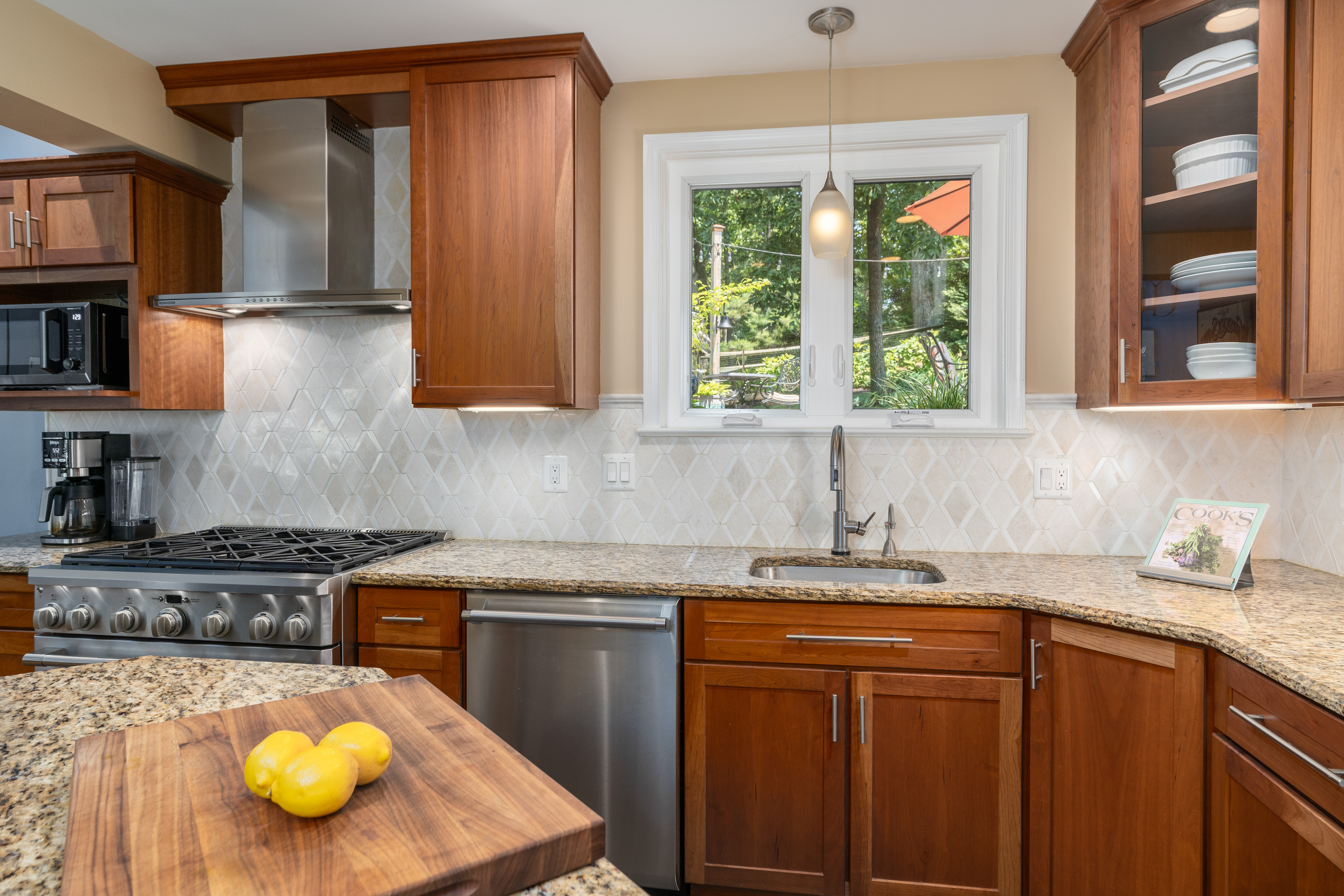 7303 Fort Hunt Road Alexandria, VA 22307 - Photo 4 of 11 a kitchen with stainless steel appliances granite countertop a sink a stove and a wooden cabinets