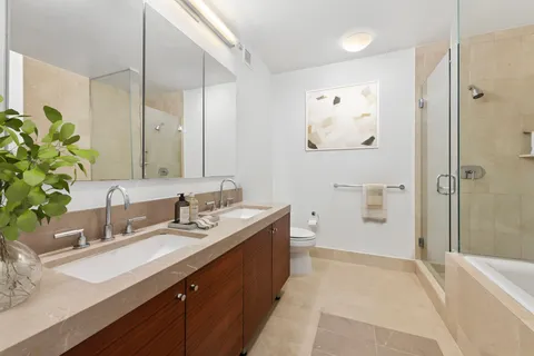 a spacious bathroom with a granite countertop sink mirror and a
