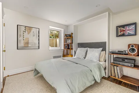a view of a backyard with table and chairs and potted plants and large trees