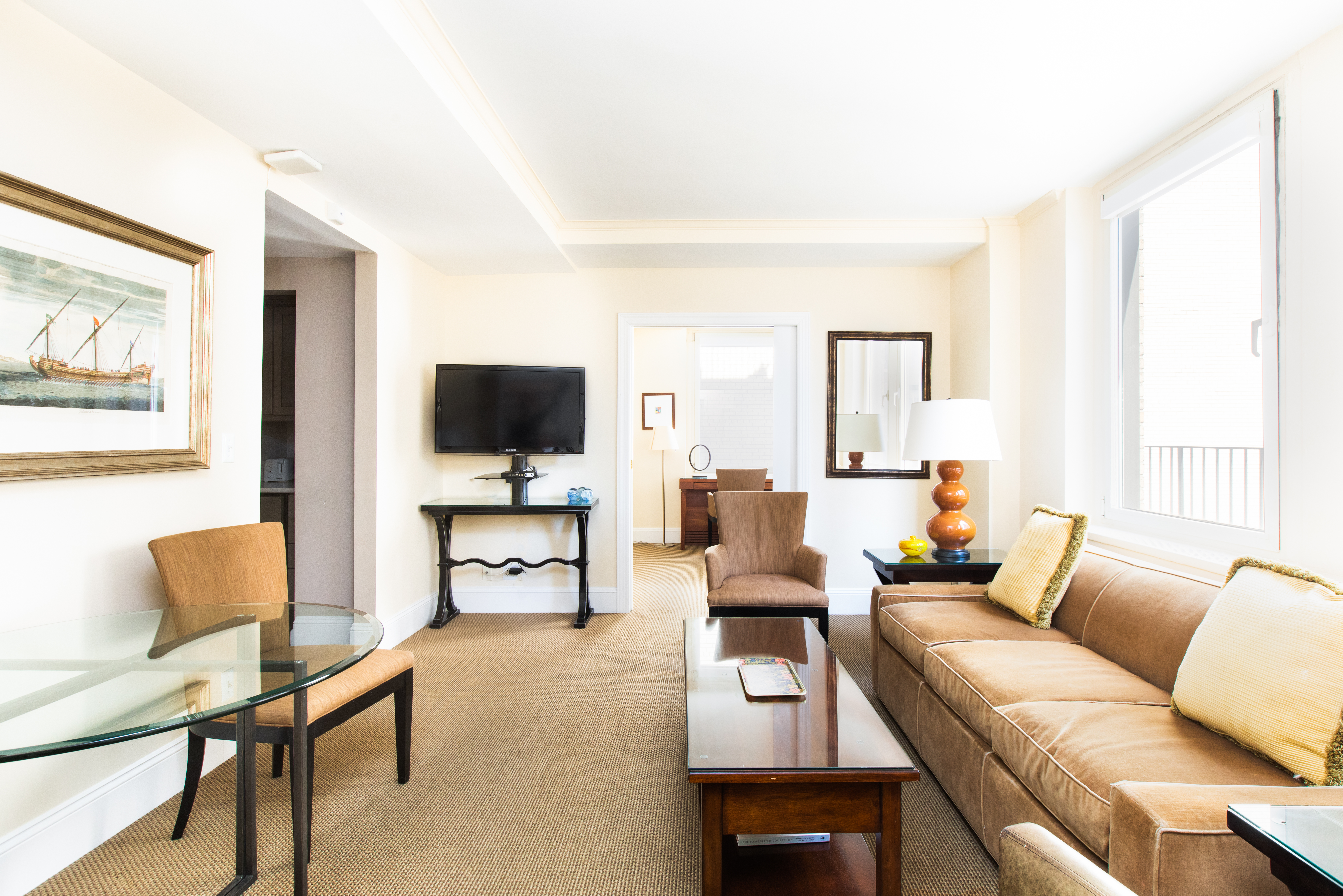 111 East 56th Street, Unit 1705 Manhattan, NY 10022 - Photo 4 of 12 a living room with furniture and a flat screen tv