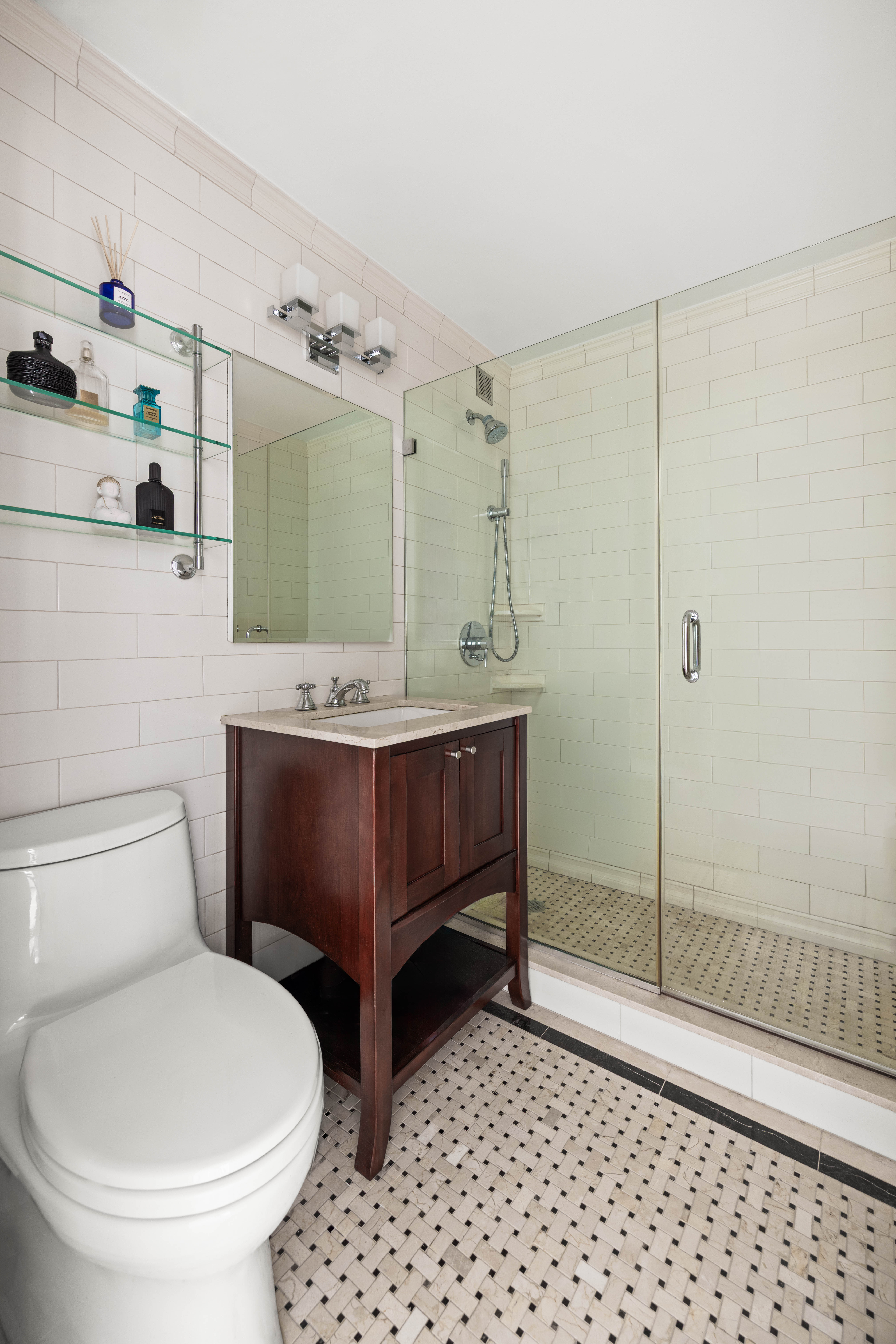 80 Park Avenue, Unit 18B Manhattan, NY 10016 - Photo 9 of 10 a bathroom with a sink a toilet and shower