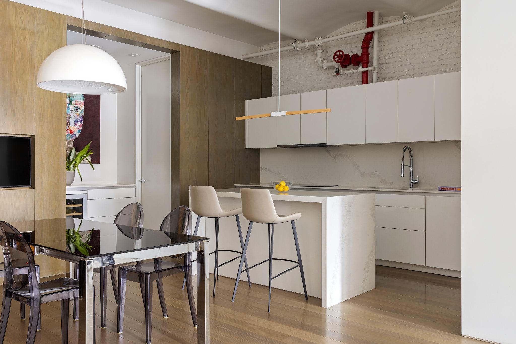 543 Broadway, Unit 6 Manhattan, NY 10012 - Photo 3 of 13 a kitchen with stainless steel appliances cabinets and a table