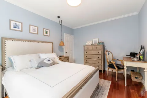 a bedroom with a bed and a bookshelf