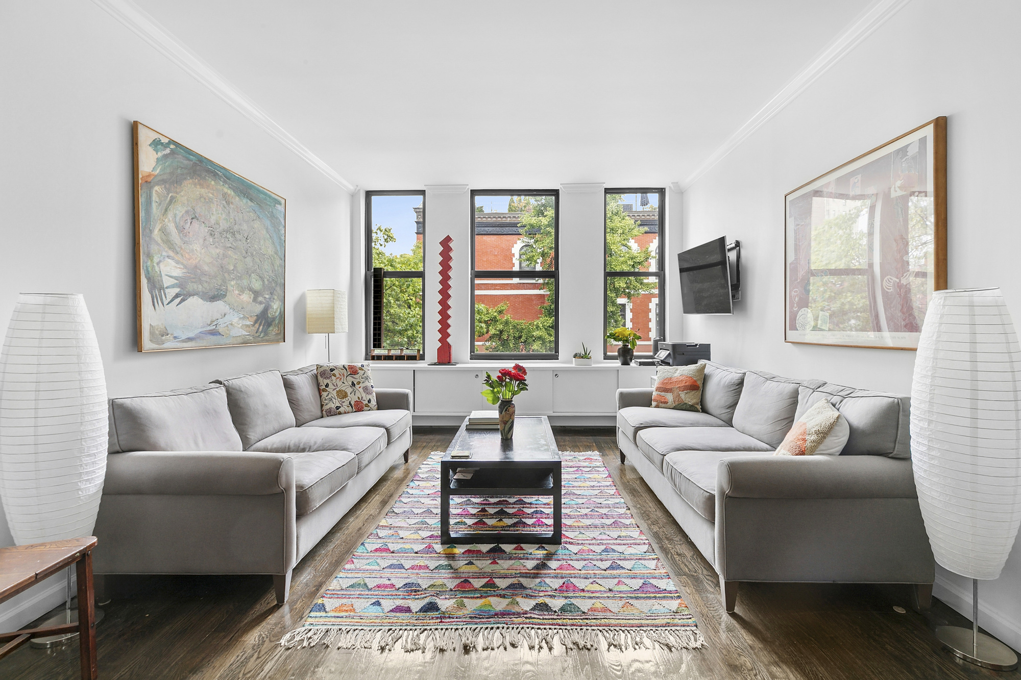 a living room with furniture wooden floor and window