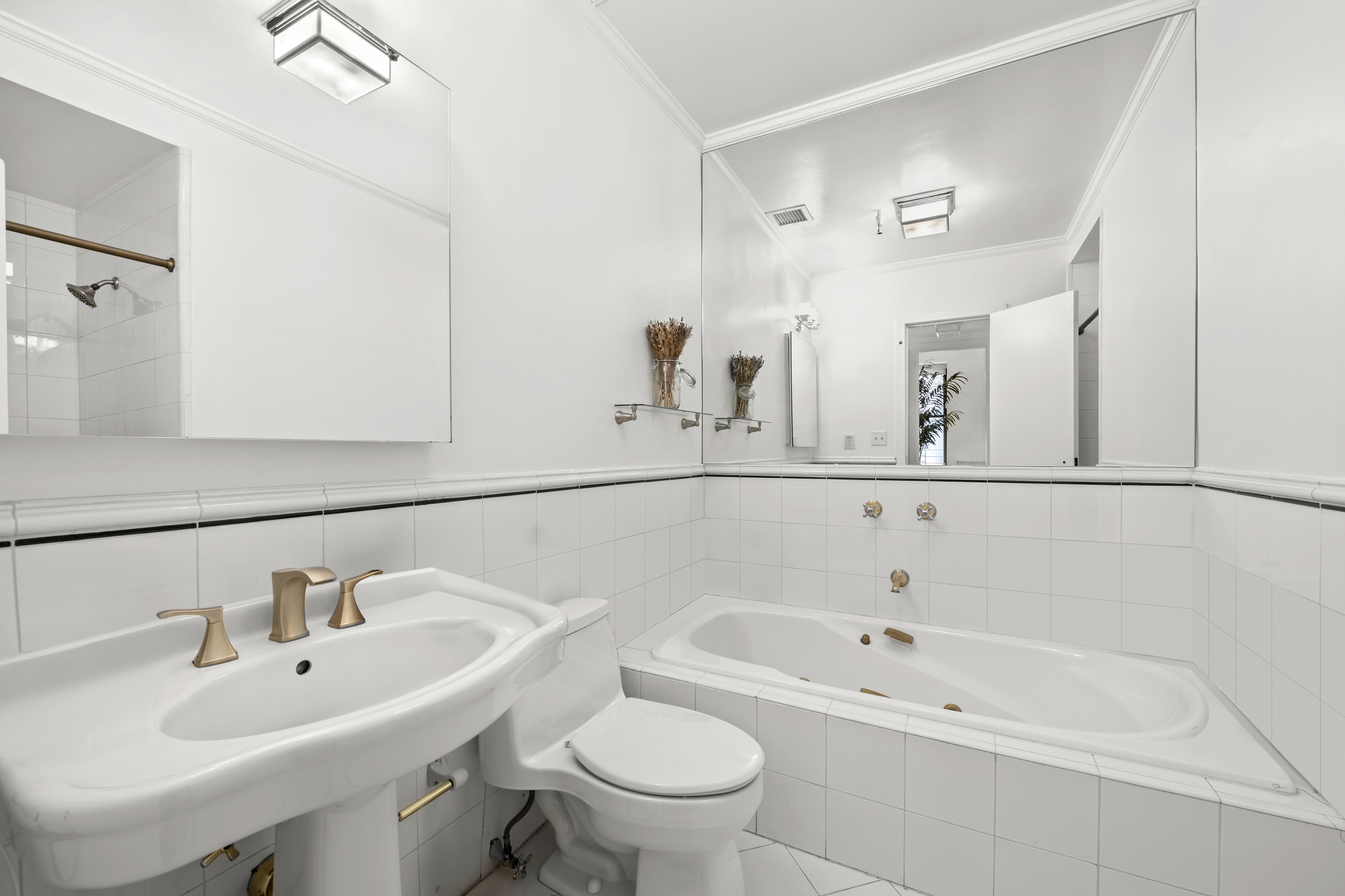 120 West 18th Street, Unit 2A Manhattan, NY 10011 - Photo 10 of 14 a bathroom with a sink a toilet and a mirror