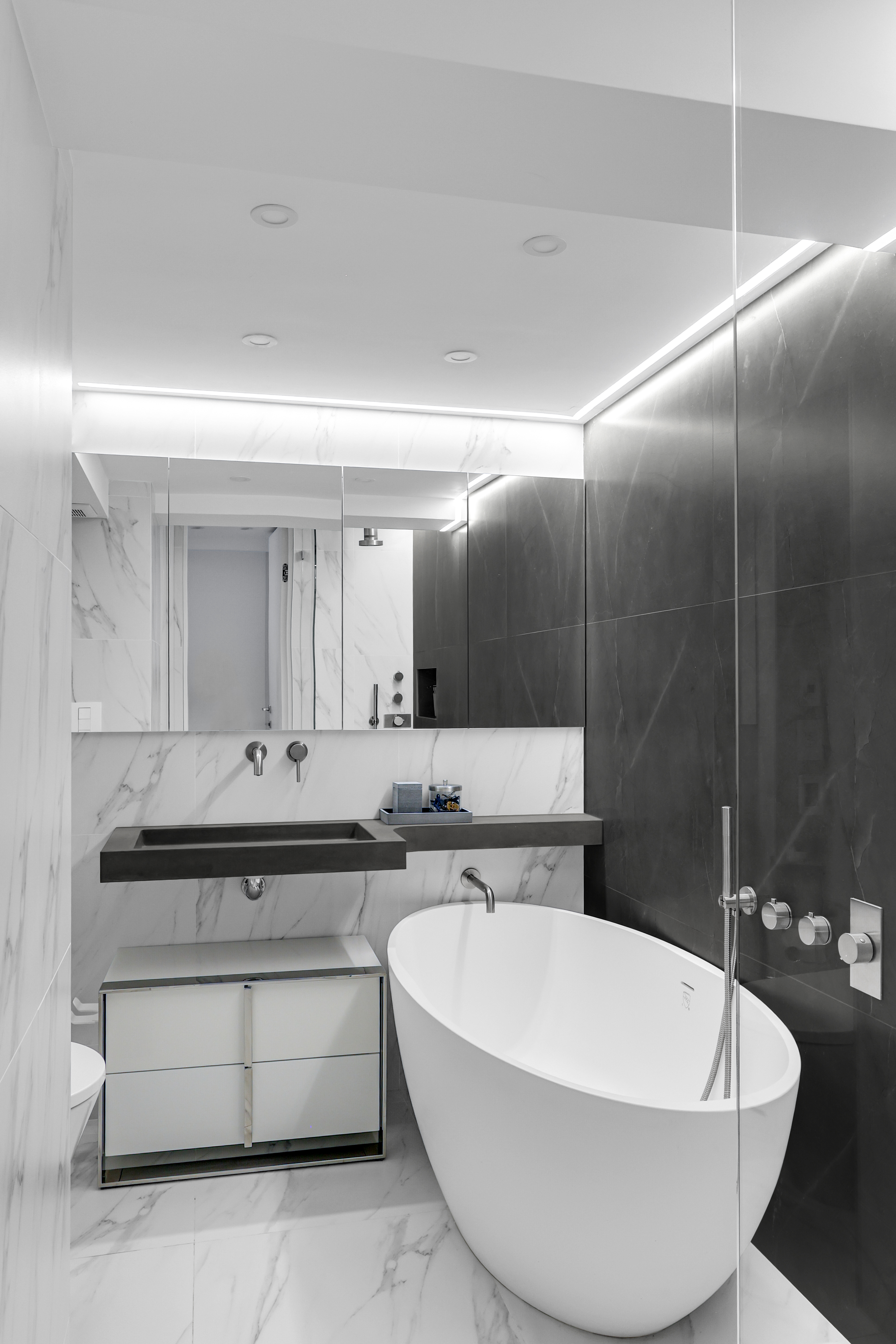 120 Central Park South, Unit 2 B C Manhattan, NY 10019 - Photo 9 of 13 a bathroom with a white bath tub a mirror and a sink