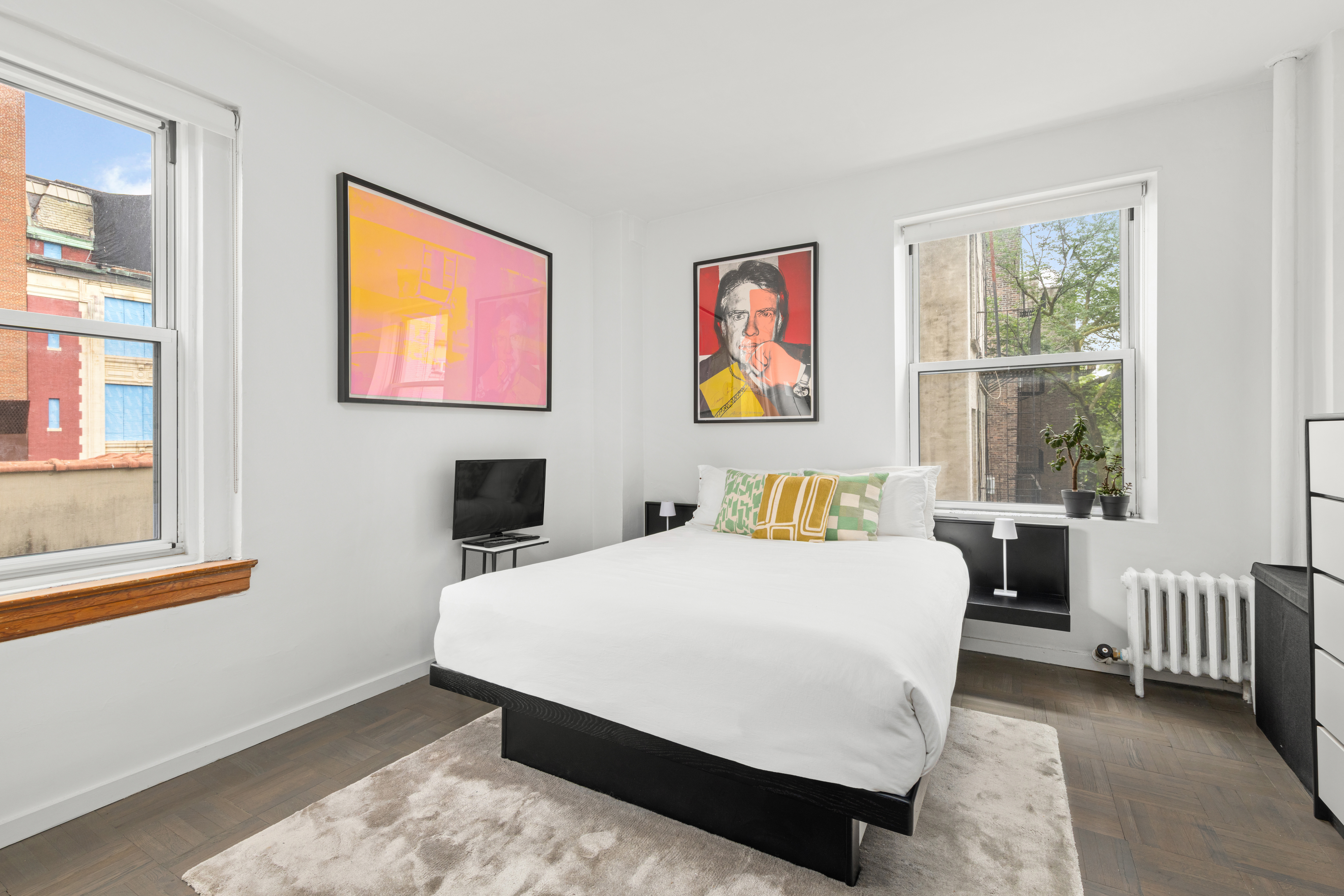 131 Avenue B, Unit 4A Manhattan, NY 10009 - Photo 5 of 11 a bedroom with a bed and a window