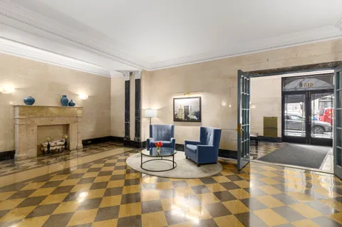 a lobby with furniture and rug