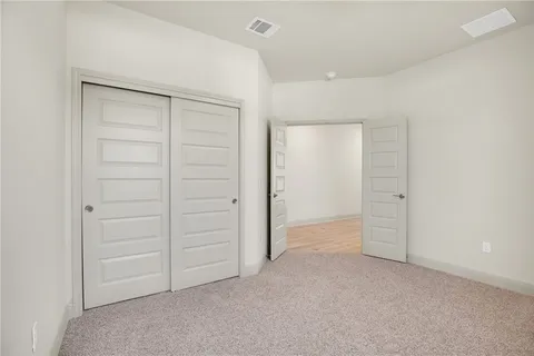 an empty room with closet area