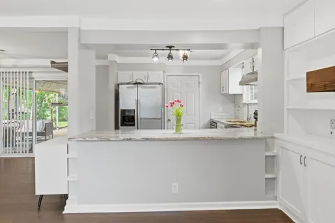 a kitchen with stainless steel appliances a sink stove and refrigerator
