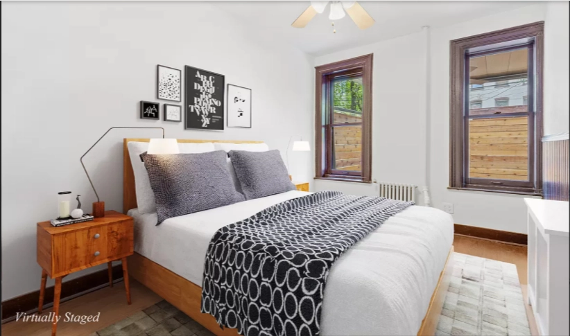 580 Decatur Street, Unit 1 Brooklyn, NY 11233 - Photo 4 of 8 a bedroom with a bed and wooden floor