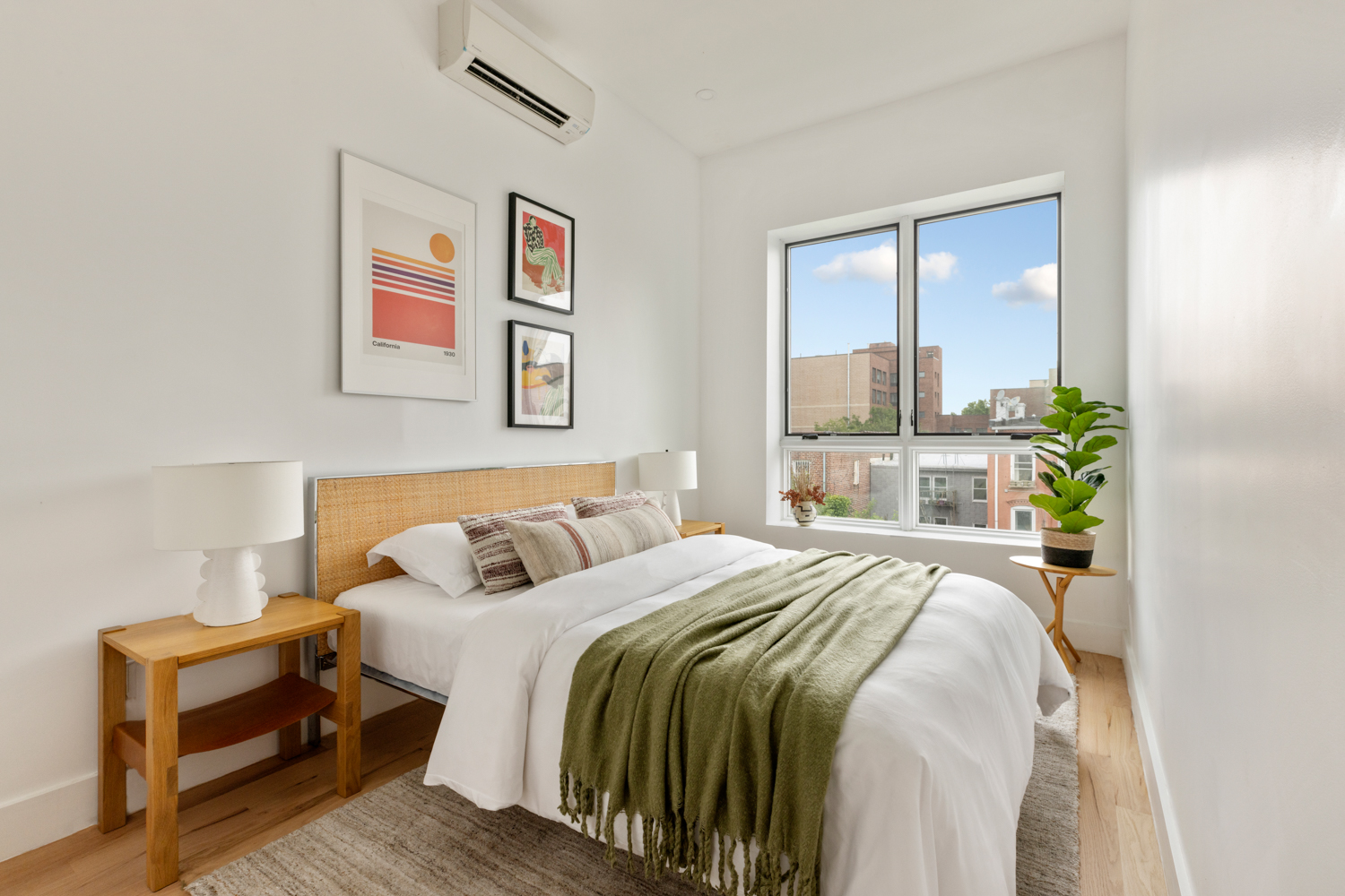 185 Withers Street, Unit 2 Brooklyn, NY 11211 - Photo 10 of 13 a bedroom with a bed painting on wall and a large window