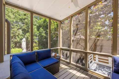 a view of a living room with wooden floor and windows