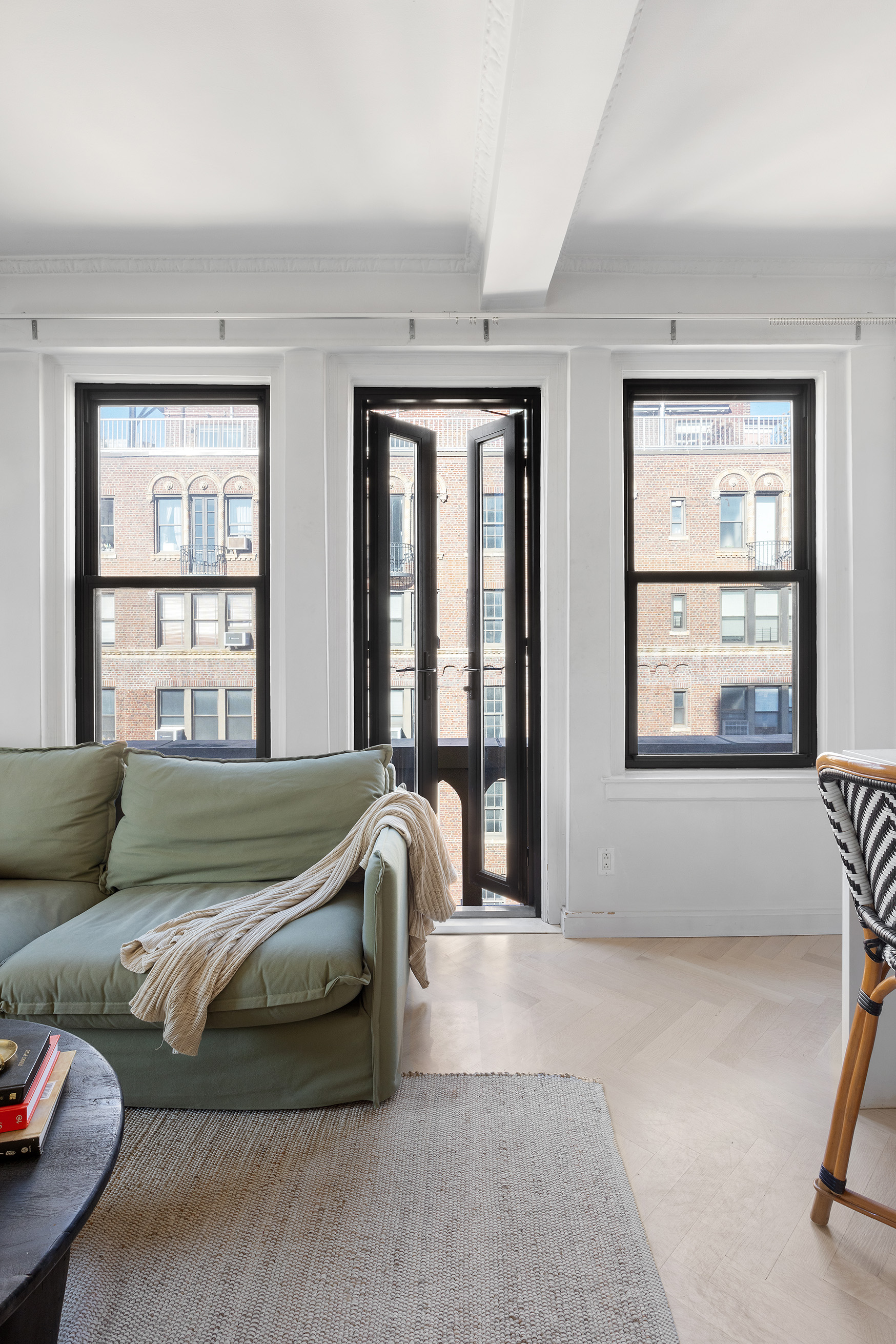 26 East 10th Street, Unit 11G Manhattan, NY 10003 - Photo 2 of 14 a living room with furniture and a window
