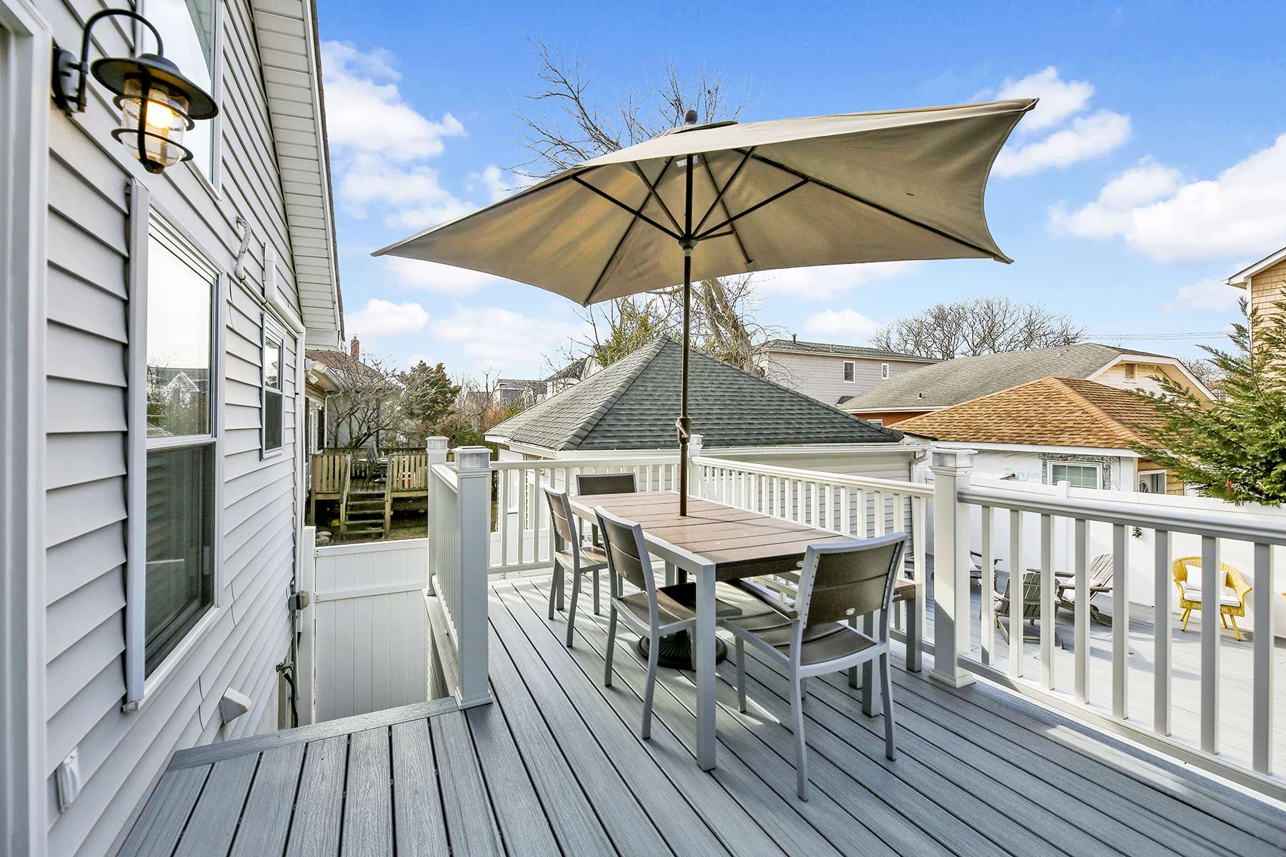 4-53 Beach 142nd Street Queens, NY 11694 - Photo 33 of 39 a view of a roof deck with table and chairs under an umbrella