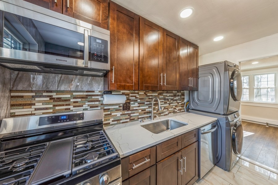 224-46 Horace Harding Expressway, Unit 630 Queens, NY 11364 - Photo 16 of 29 a kitchen with a stove and a sink