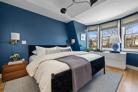 a spacious bedroom with a large bed and a large window