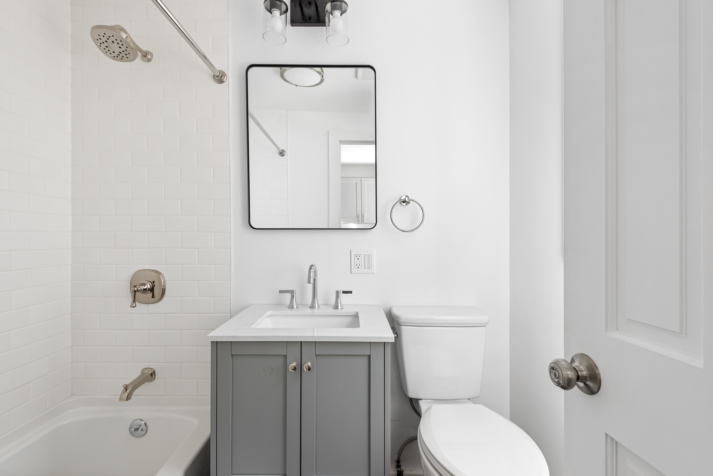 404 A 17th Street, Unit 3 Brooklyn, NY 11215 - Photo 6 of 9 a bathroom with a toilet sink vanity tub and mirror