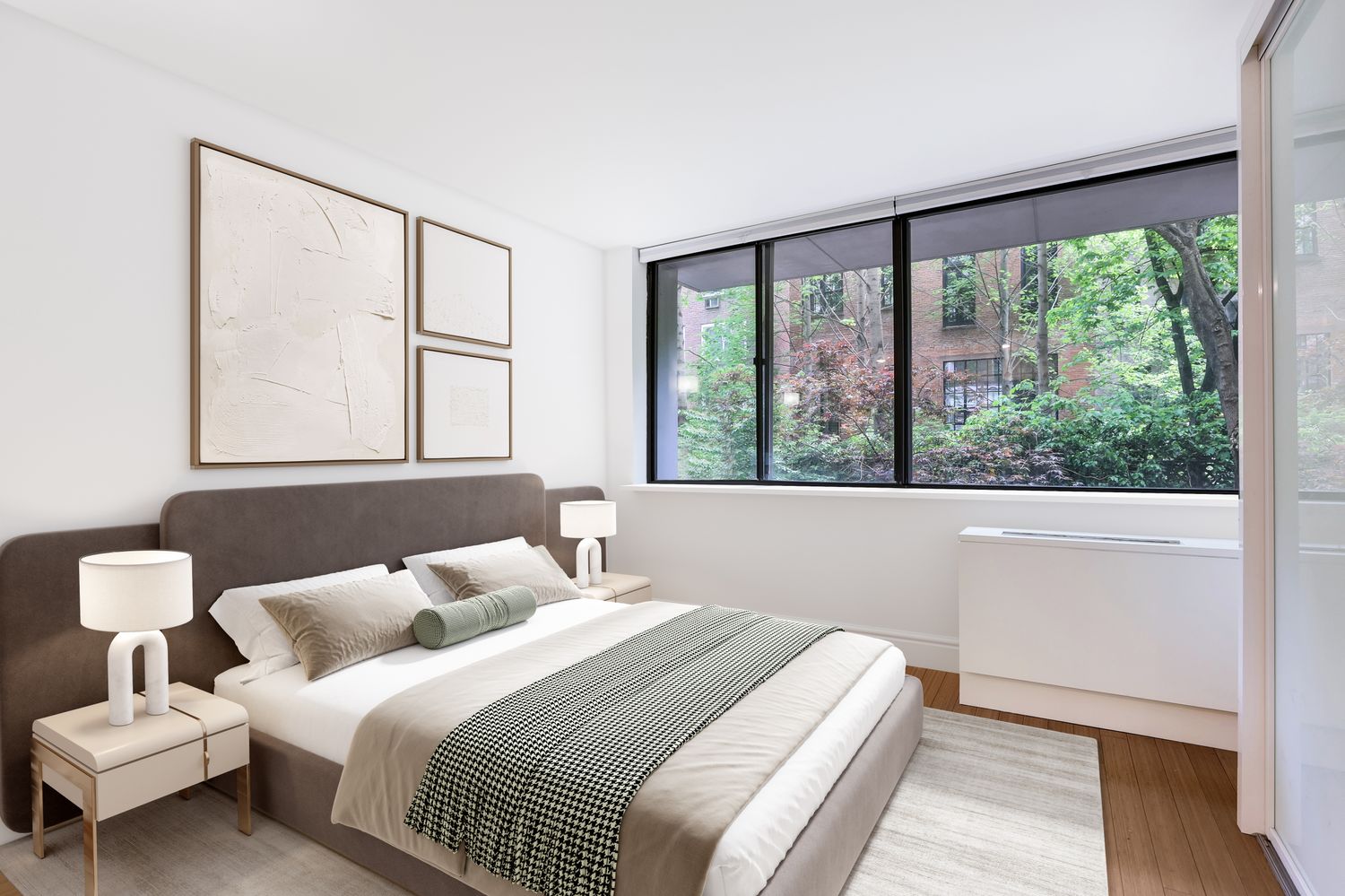 344 West 23rd Street, Unit 1E Manhattan, NY 10011 - Photo 10 of 19 a bedroom with a large bed and a large window