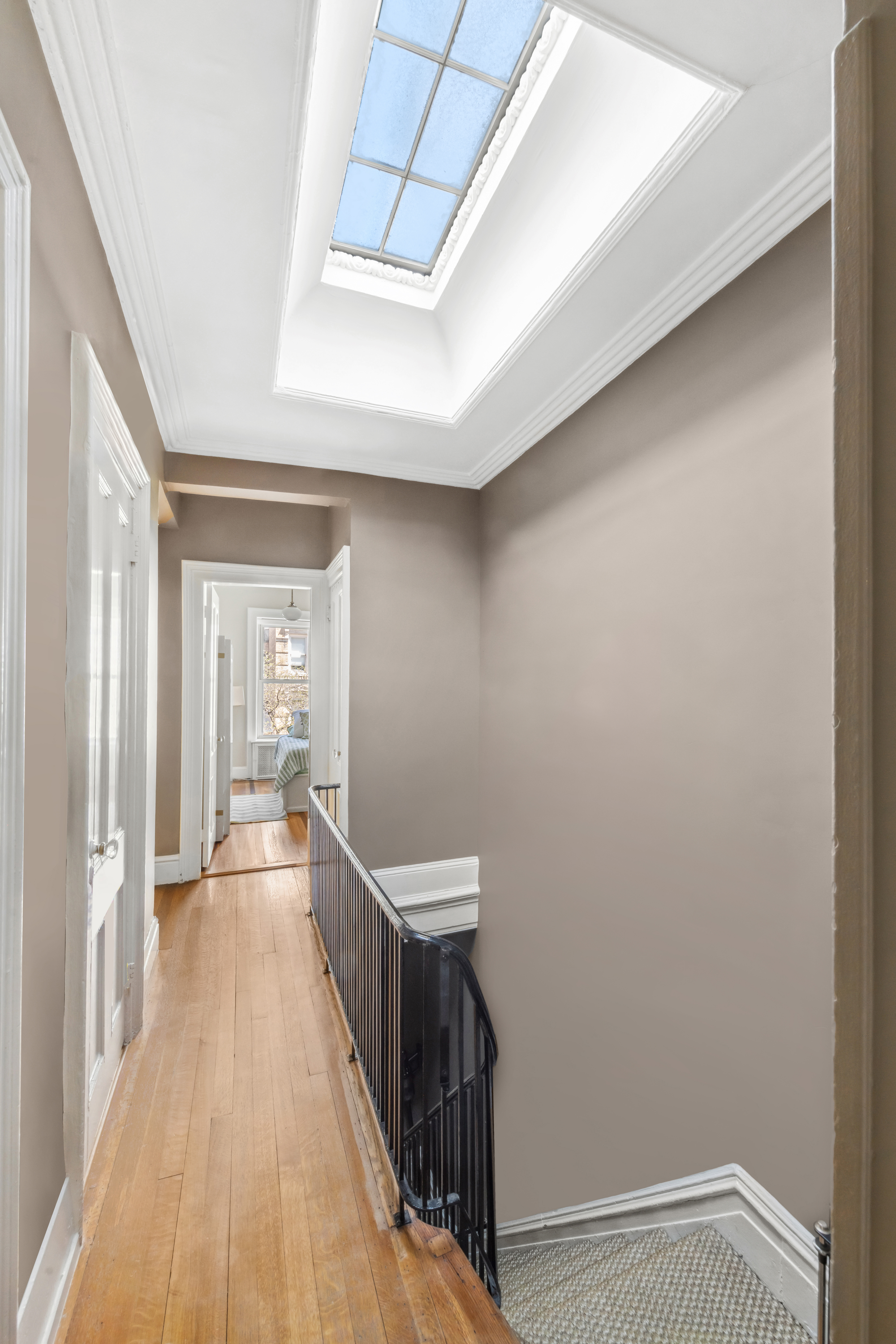 240 East 62nd Street Manhattan, NY 10065 - Photo 9 of 12 a view of a hallway with wooden floor and staircase