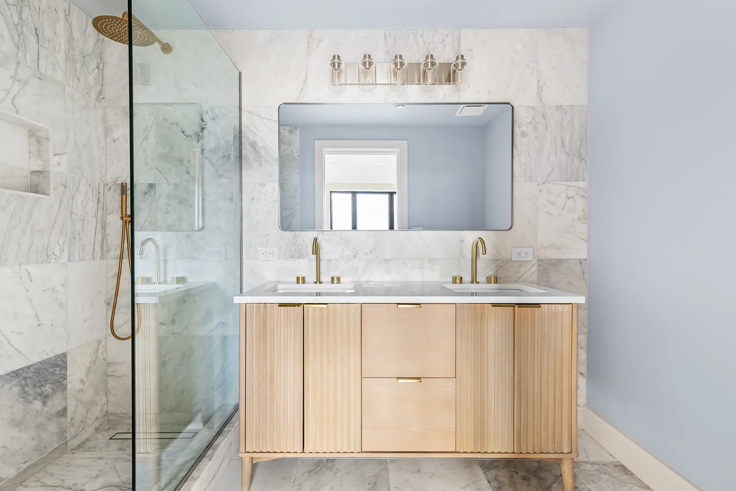 a bathroom with a granite countertop sink a mirror and shower