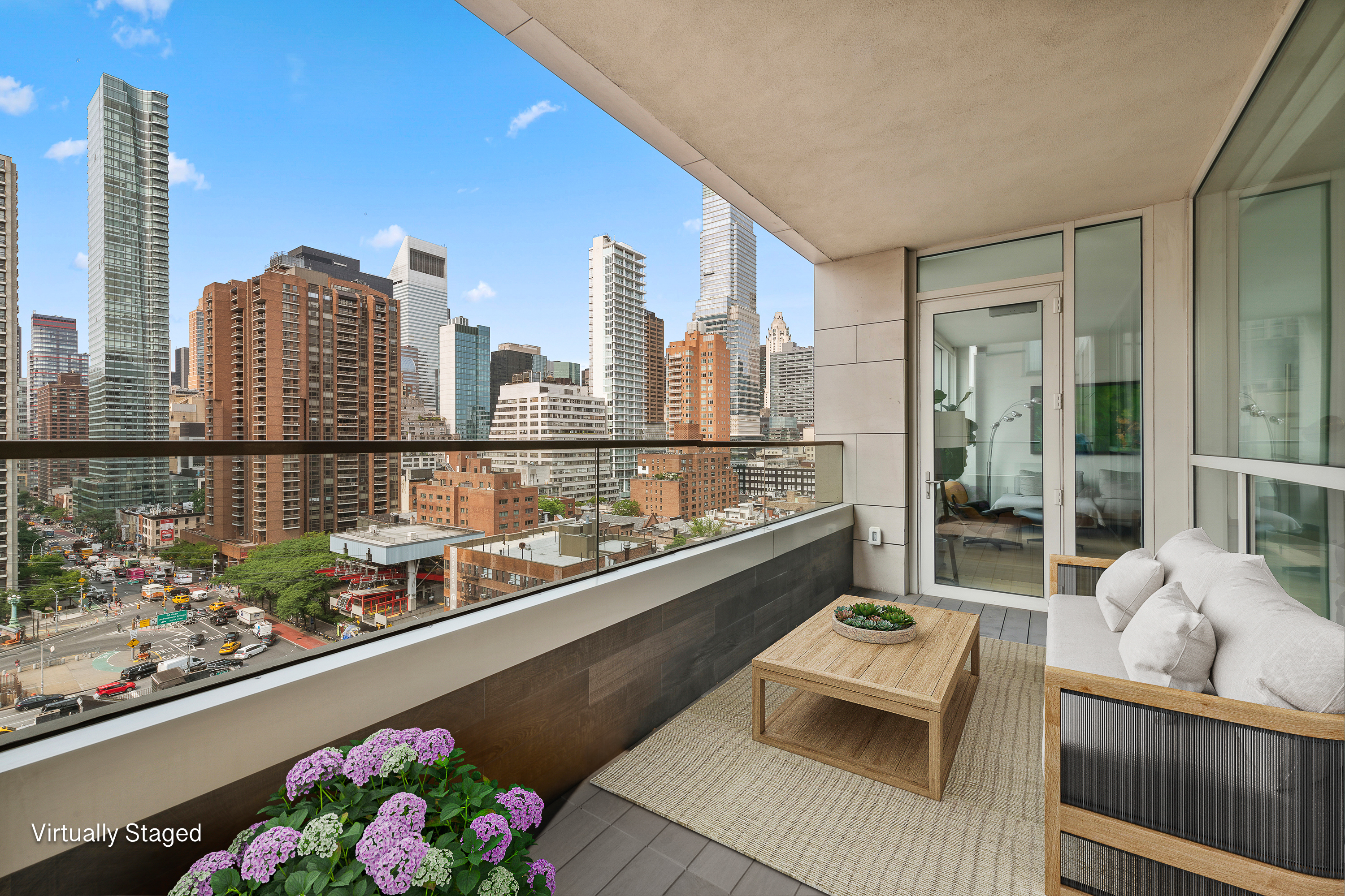 301 East 61st Street, Unit 12B Manhattan, NY 10065 - Photo 7 of 10 a city view from a balcony with furniture