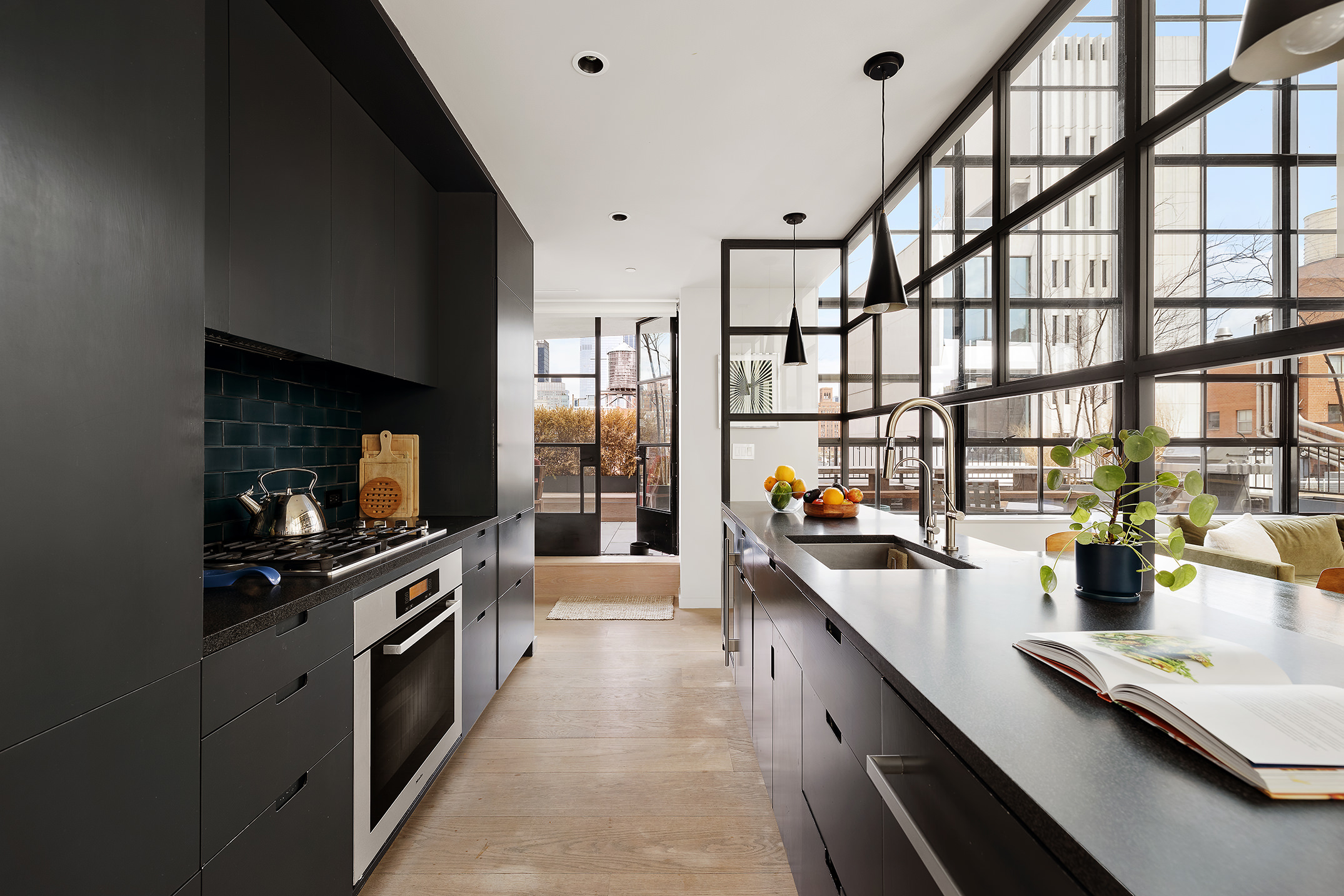 456 West 19th Street, Unit PHG Manhattan, NY 10011 - Photo 3 of 12 a kitchen with stainless steel appliances a sink and a counter top space