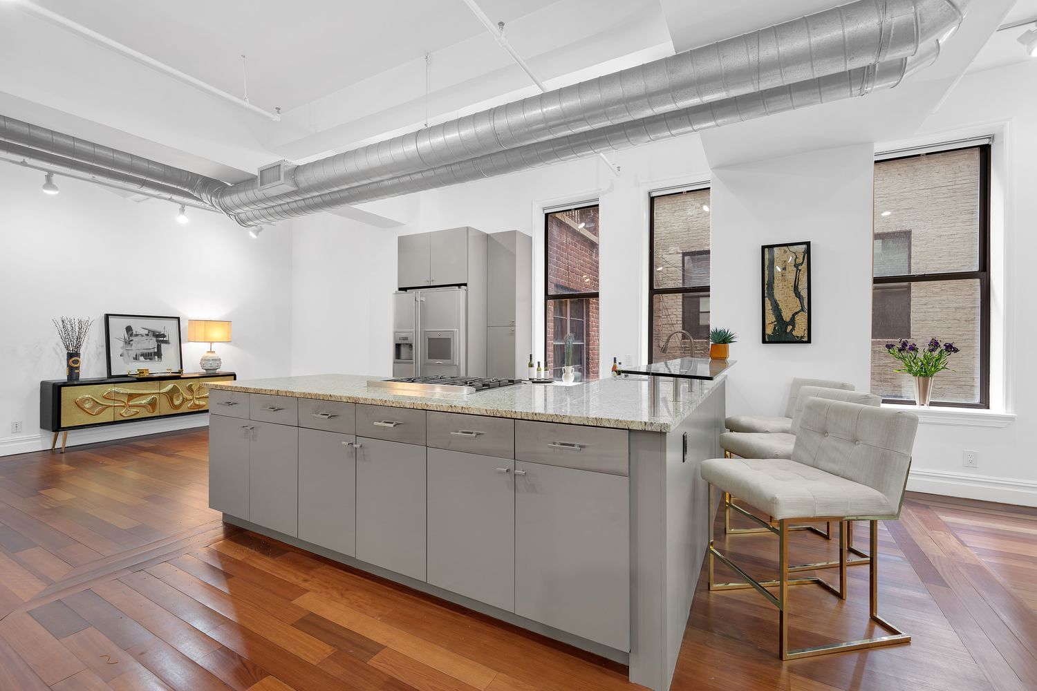 a spacious bathroom with a granite countertop sink and a mirror