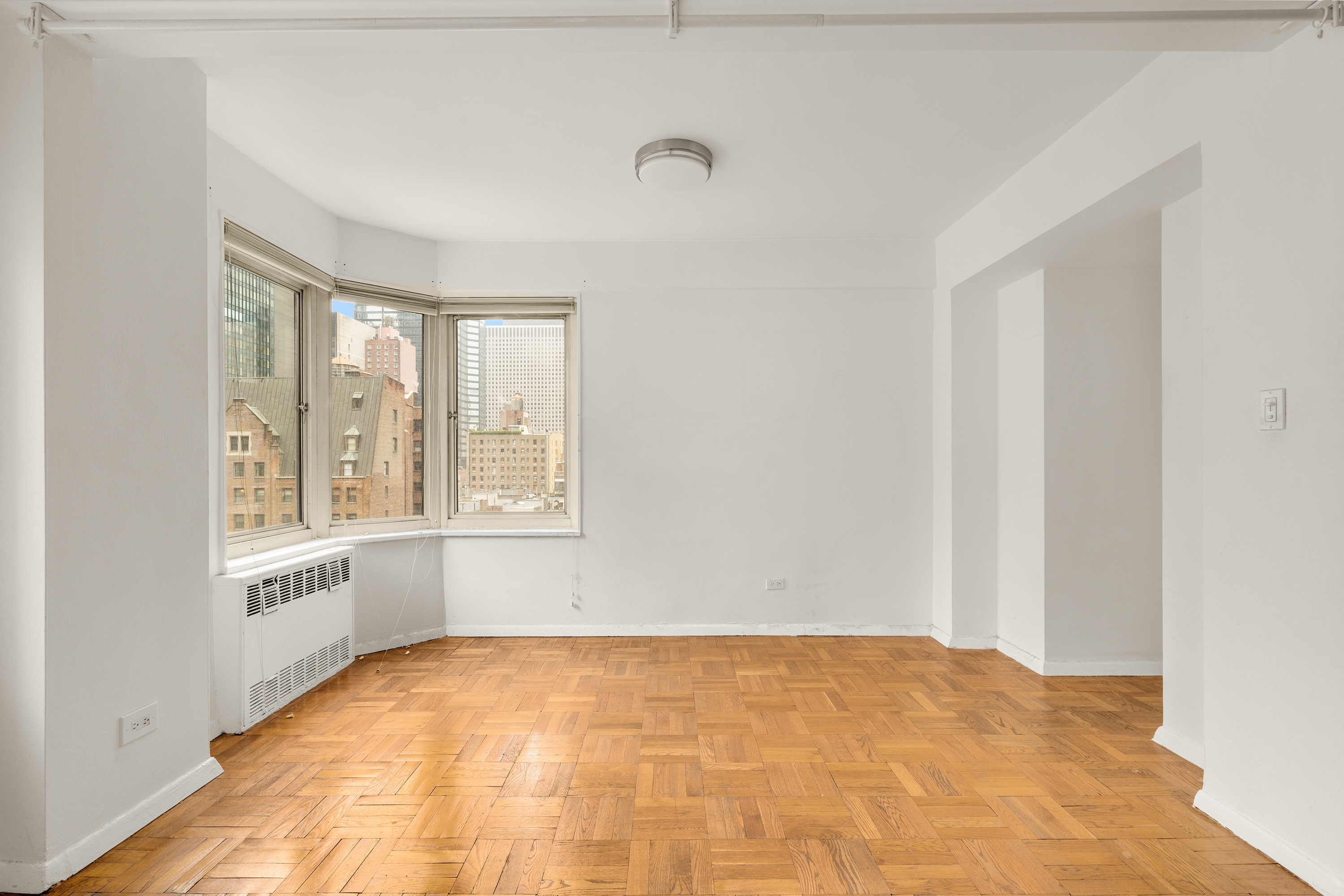 249 East 48th Street, Unit 12A Manhattan, NY 10017 - Photo 4 of 9 a view of an empty room with a window