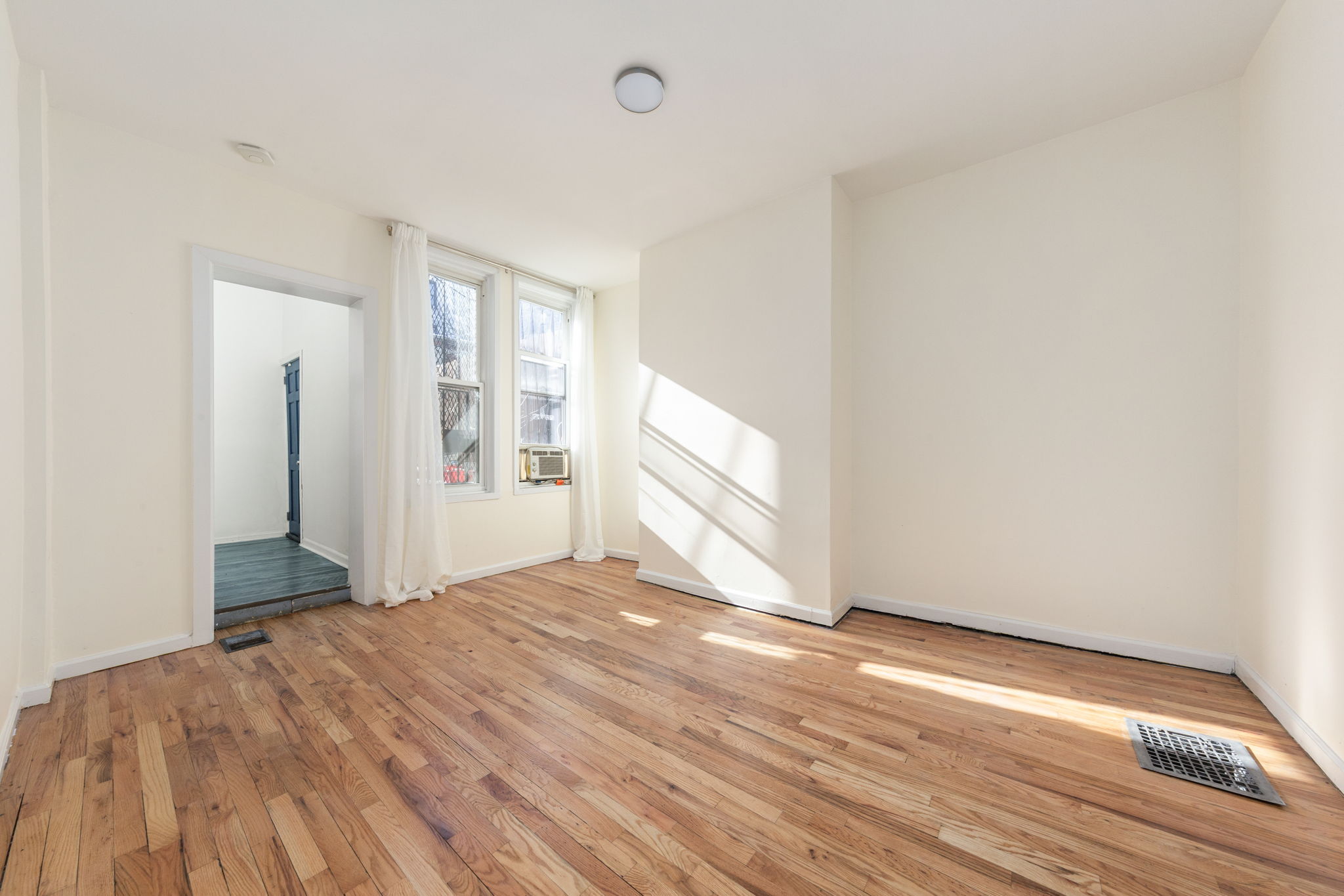 1218 Saint Marks Avenue Brooklyn, NY 11213 - Photo 19 of 42 a view of empty room with wooden floor and fan