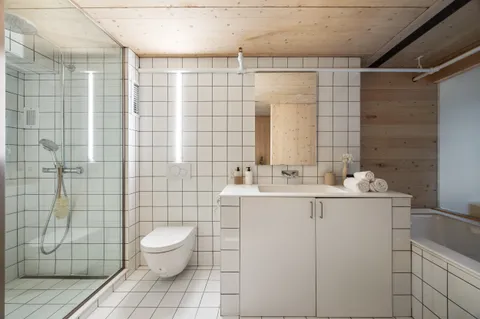 a living room with furniture and a large mirror