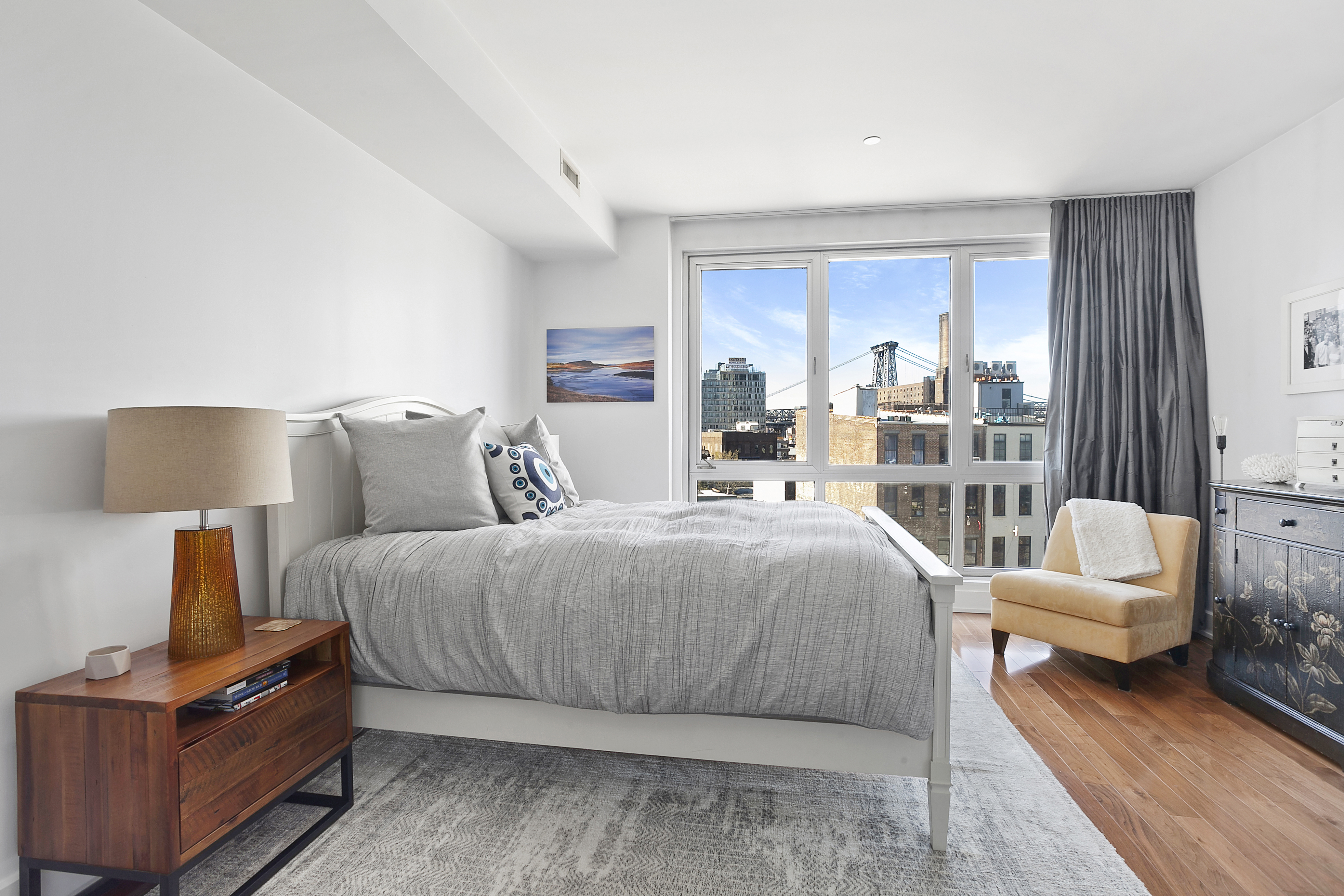 66 North 1st Street, Unit 5A Brooklyn, NY 11249 - Photo 3 of 7 a bedroom with a bed and lamp