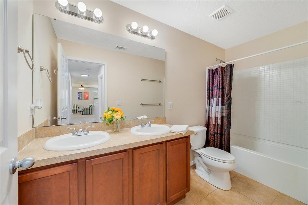 352 Giovani Boulevard Clermont, FL 34715 - Photo 33 of 46 a bathroom with a sink a toilet and shower