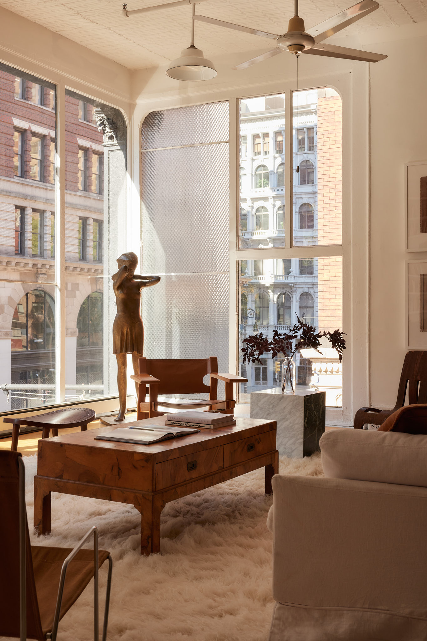 2 Bond Street, Unit 2 Manhattan, NY 10012 - Photo 3 of 16 a living room with fireplace furniture and a large window