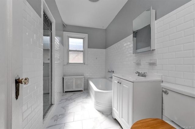 1186 Brooklyn Avenue, Unit N A Brooklyn, NY 11203 - Photo 16 of 17 a bathroom with a toilet bathtub and sink