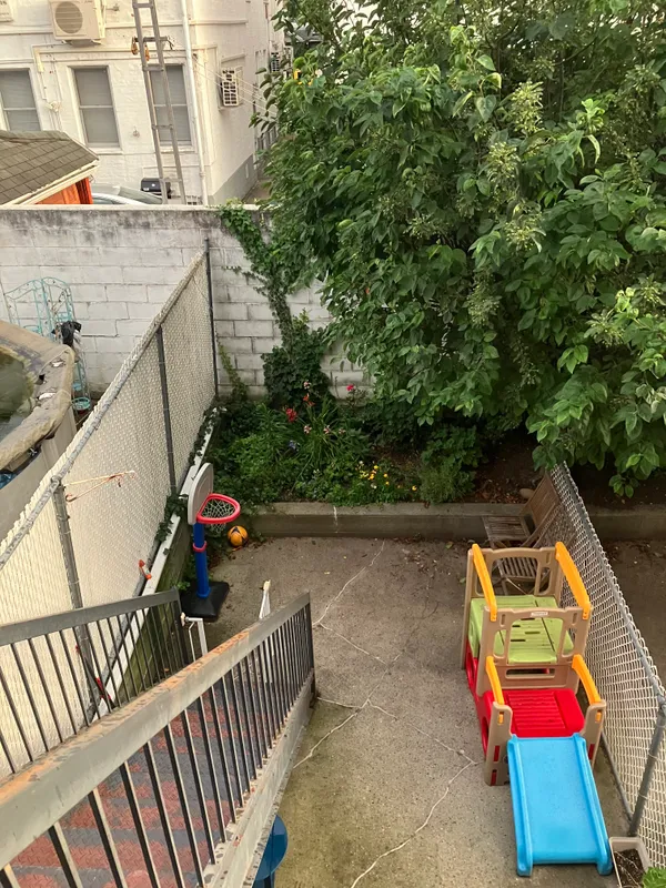 a balcony with hardwood filled with an outdoor space