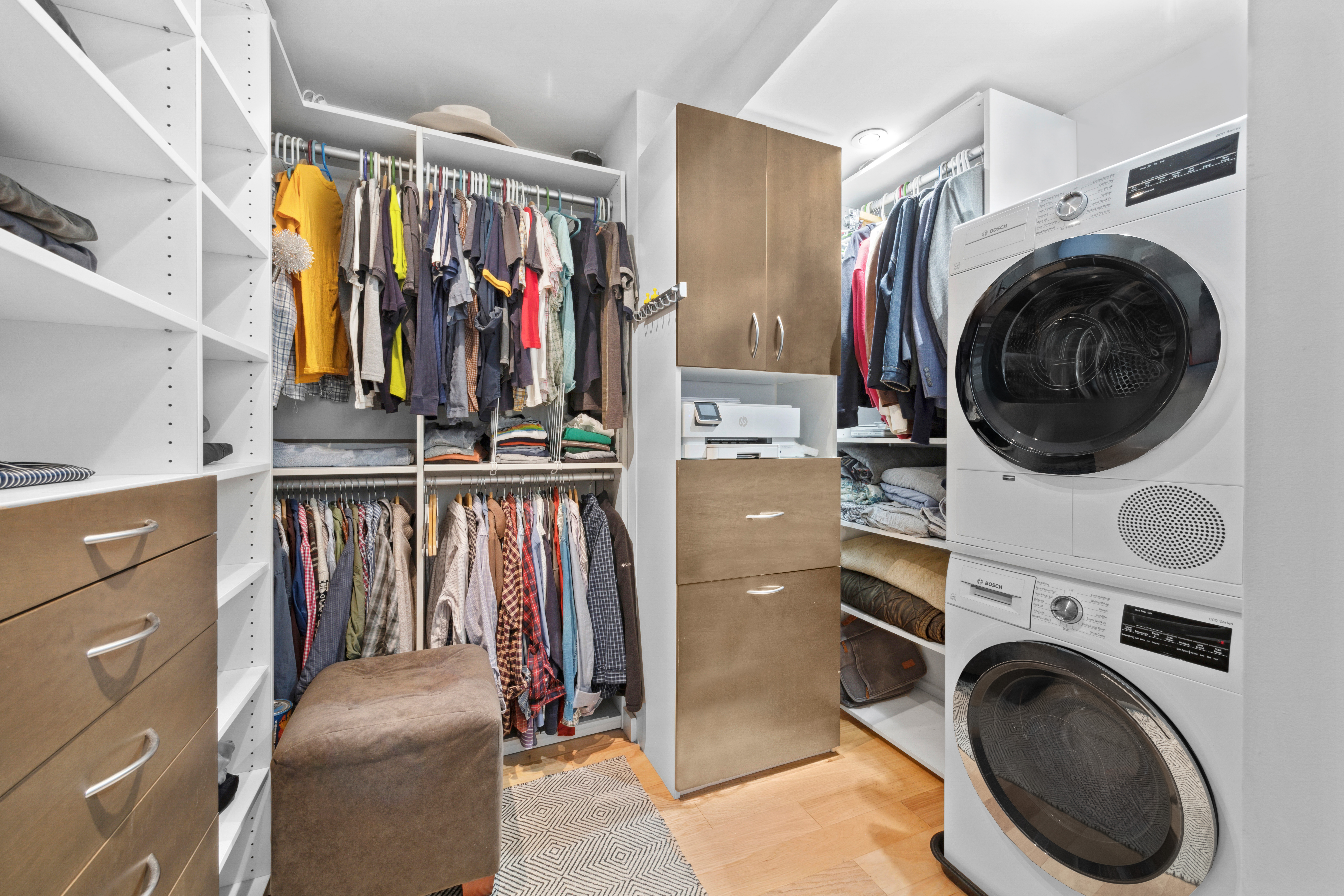 400 East 77th Street, Unit 1CD Manhattan, NY 10075 - Photo 14 of 18 a view of walk in closet with clothes shoes and a washer dryer