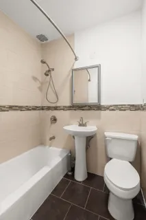 a bathroom with a sink toilet and mirror
