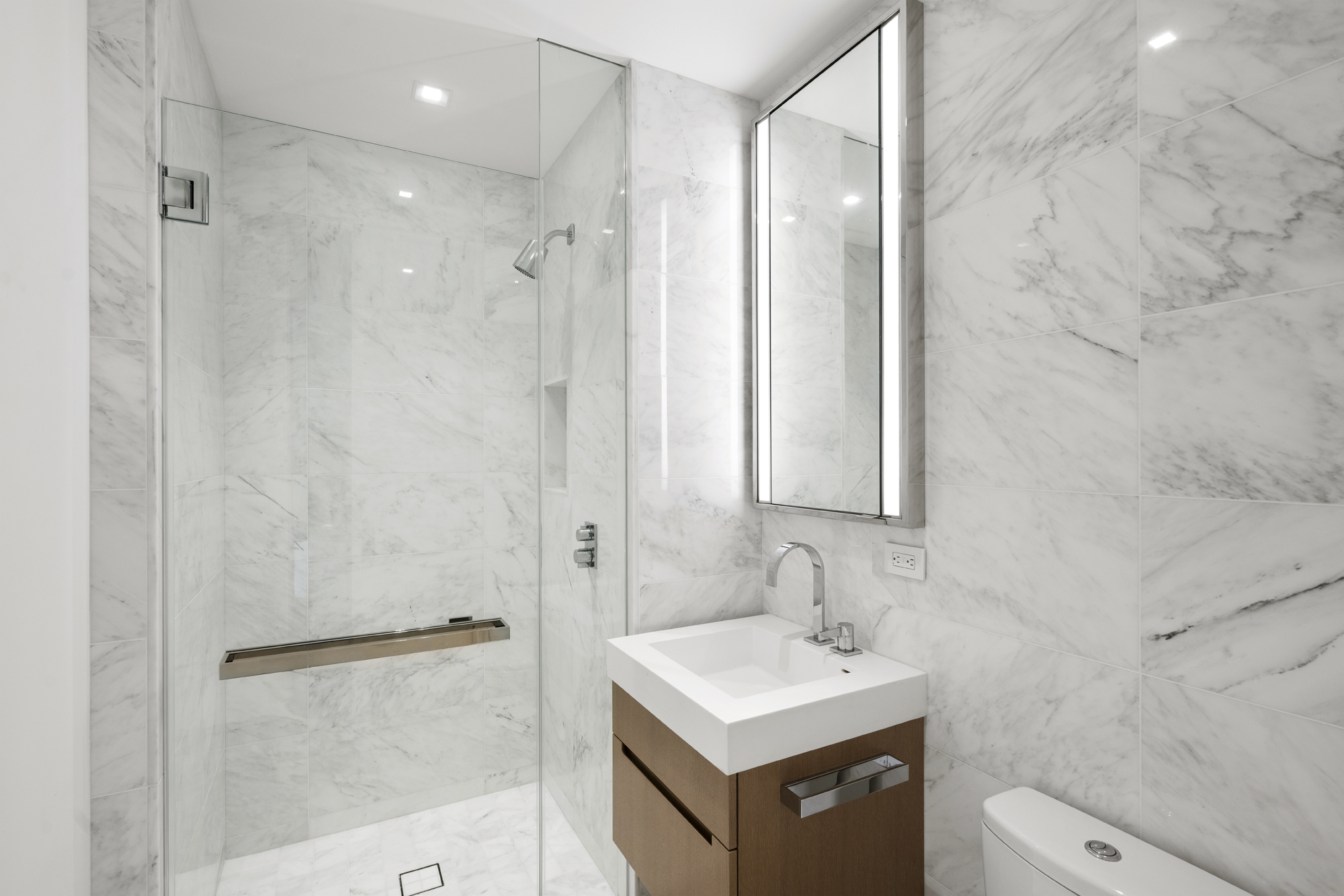 1 West End Avenue, Unit 22C Manhattan, NY 10023 - Photo 13 of 15 a bathroom with a sink a toilet and shower