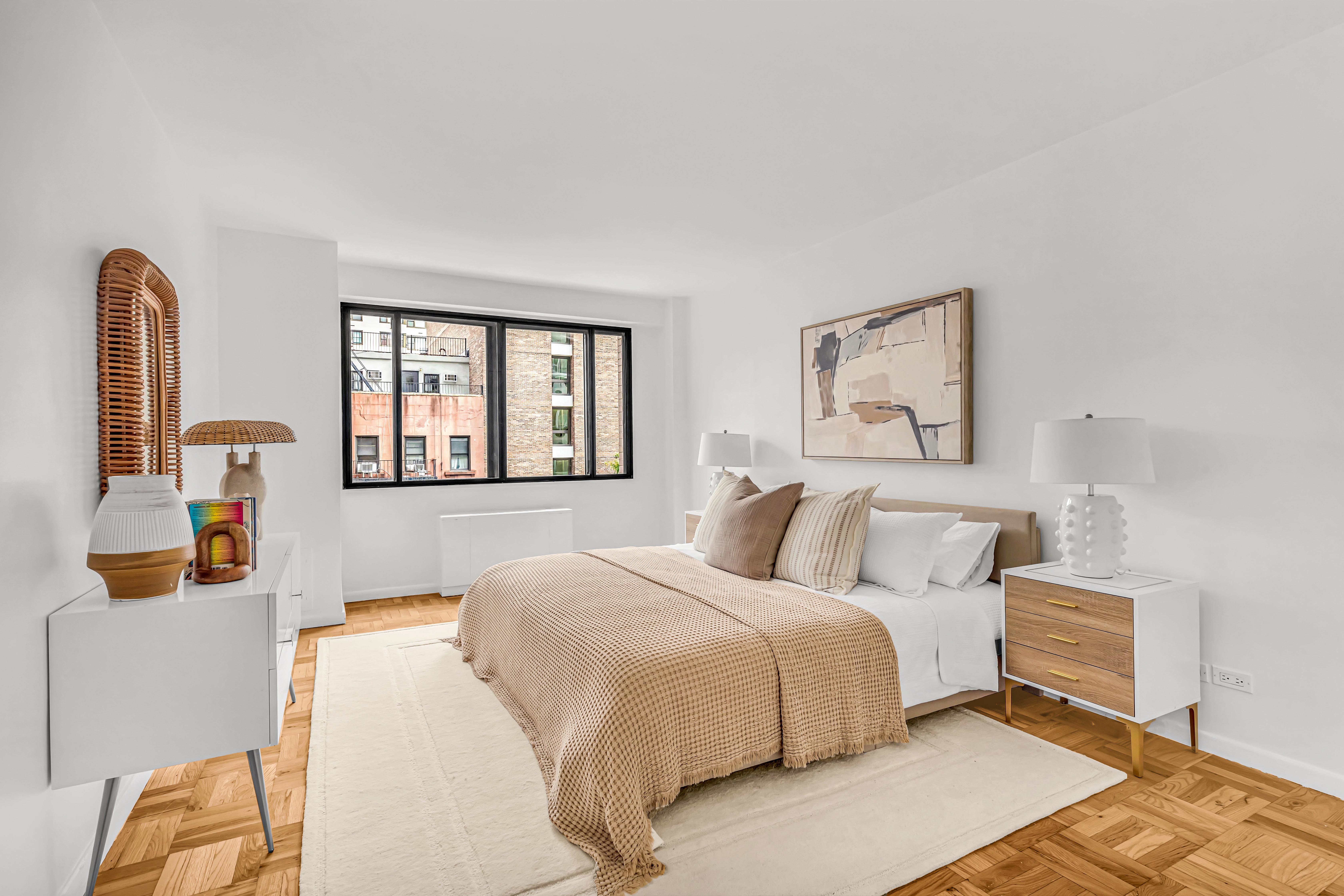 203 East 72nd Street, Unit 3E Manhattan, NY 10021 - Photo 4 of 6 a bedroom with a large bed and a window