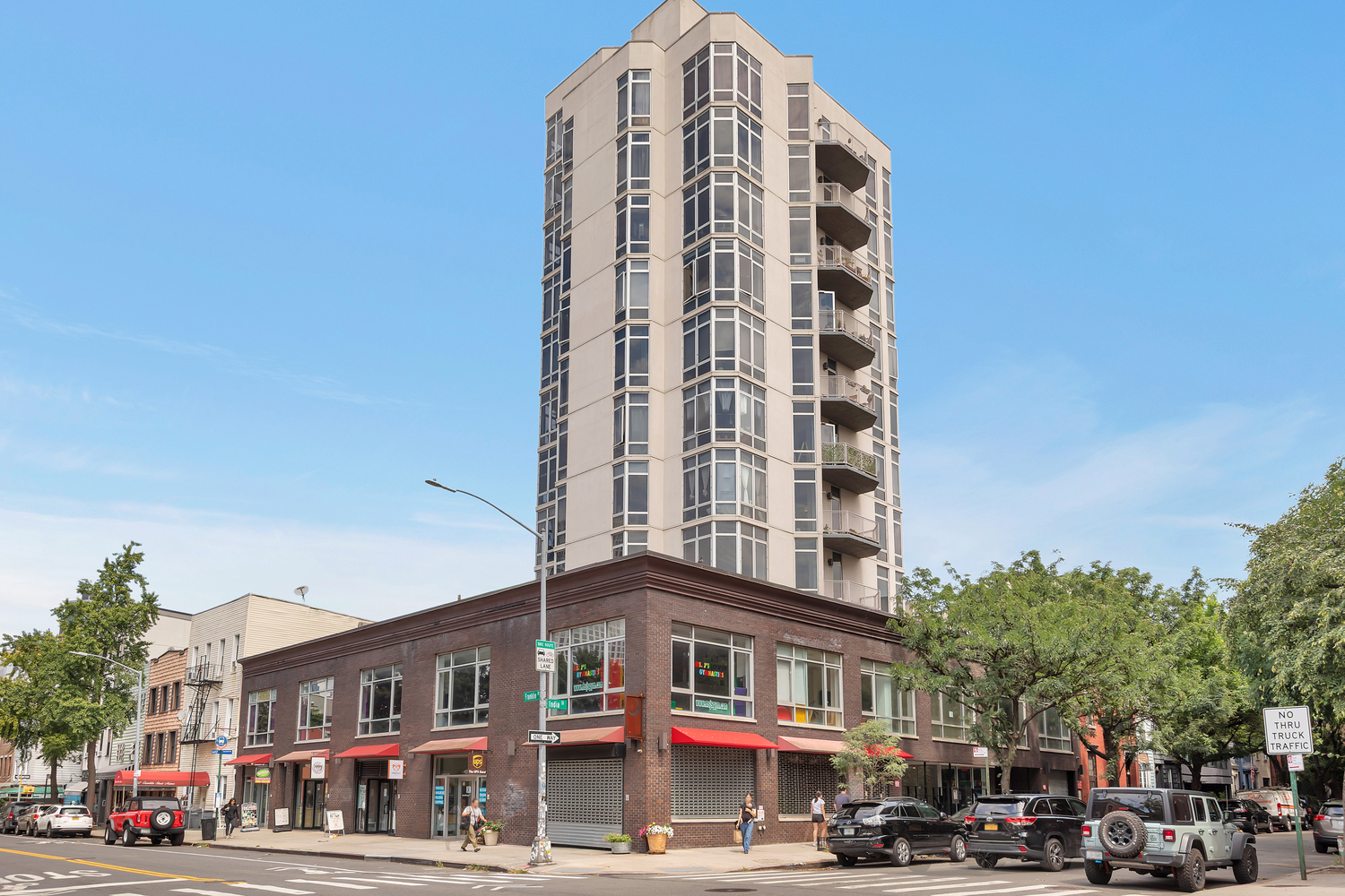 200 Franklin Street, Unit 3B Brooklyn, NY 11222 - Photo 7 of 7 a front view of a building with lot of cars and trees