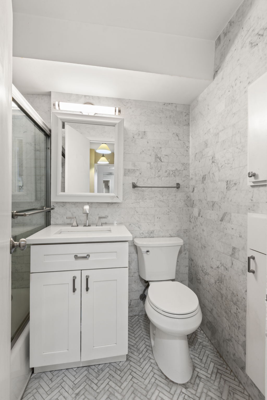 310 Lexington Avenue, Unit 9F Manhattan, NY 10016 - Photo 9 of 13 a bathroom with a toilet a sink and mirror