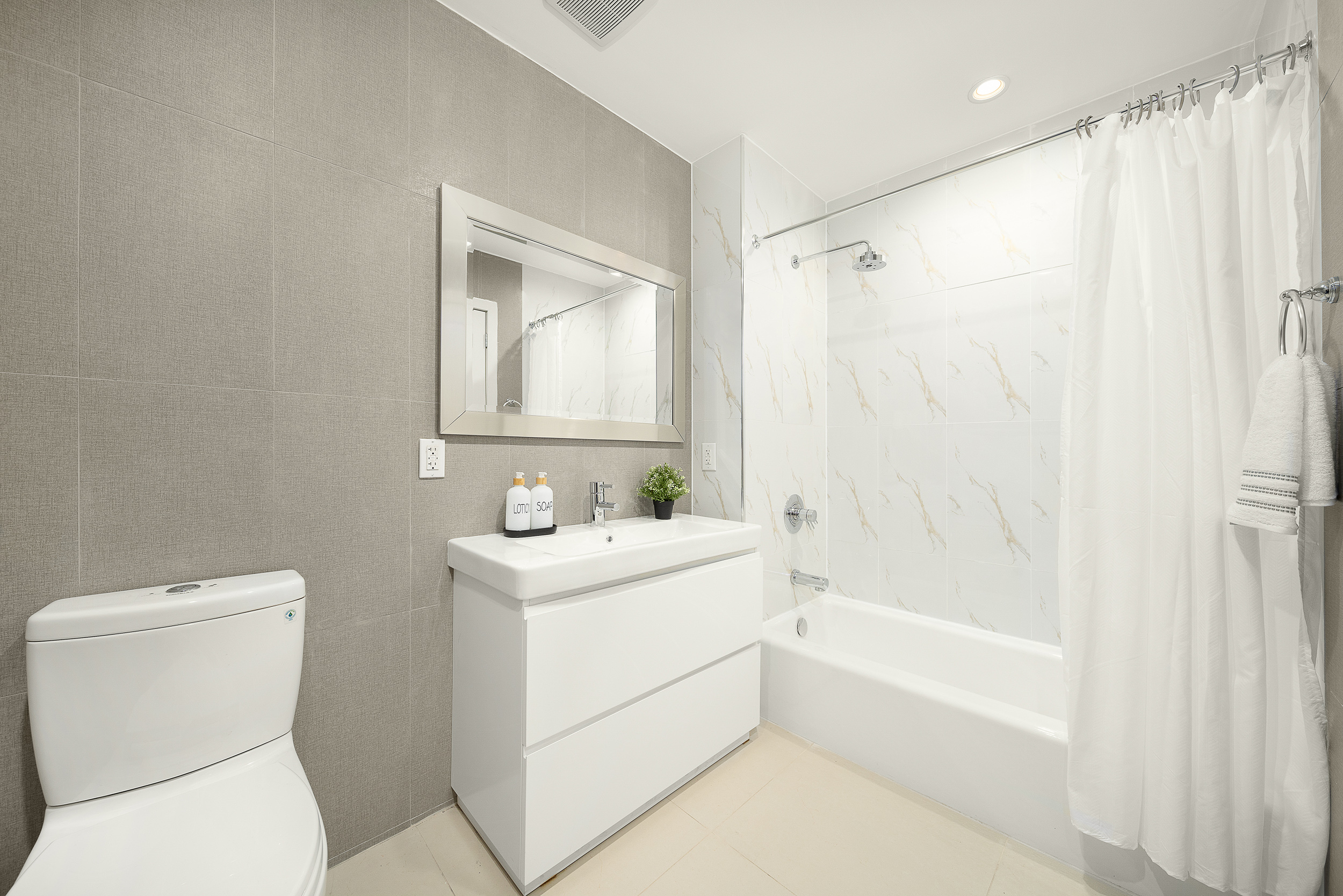 109-09 15th Avenue, Unit PHS611 Queens, NY 11356 - Photo 7 of 11 a bathroom with a toilet sink and bathtub